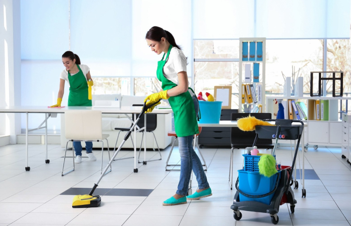 Professional Office & Commercial Cleaning team sanitising a modern office workspace