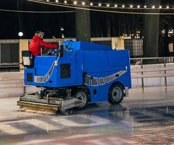 Industrial cleaning professionals using heavy-duty equipment in factory