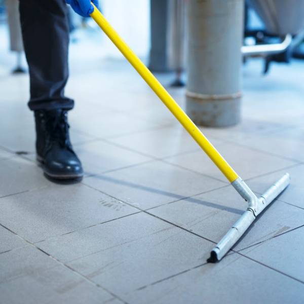 Expert cleaners maintaining hygiene in commercial warehouse facility